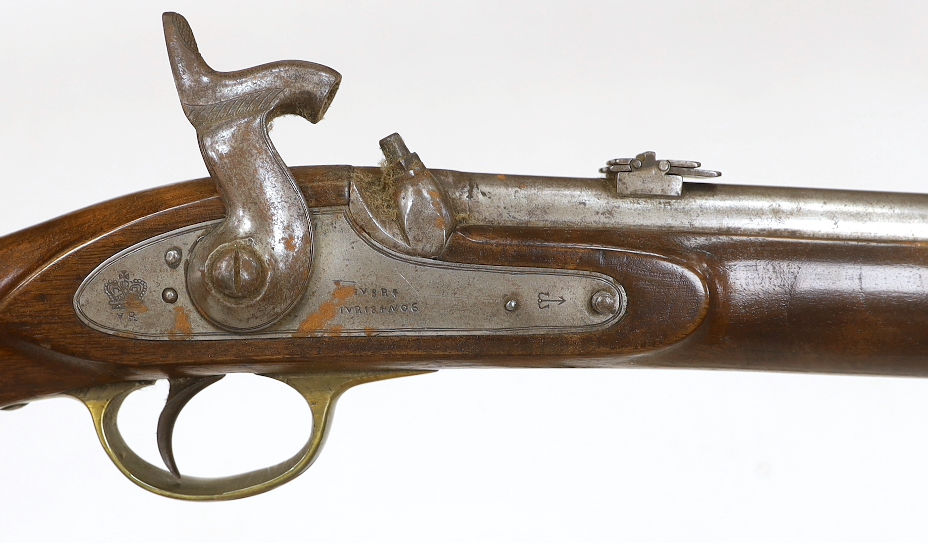 A two band percussion Military carbine of Indian use, regulation brass mounts, fold leaf rear sight, regulation brass mount, lock with Indian marks and also crowned VR, barrel 66.2cm